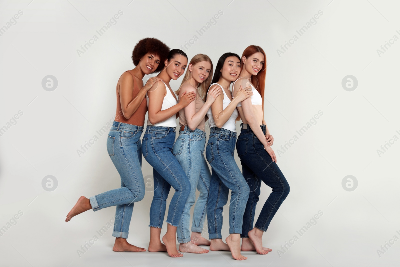 Photo of Group of beautiful young women on light grey background