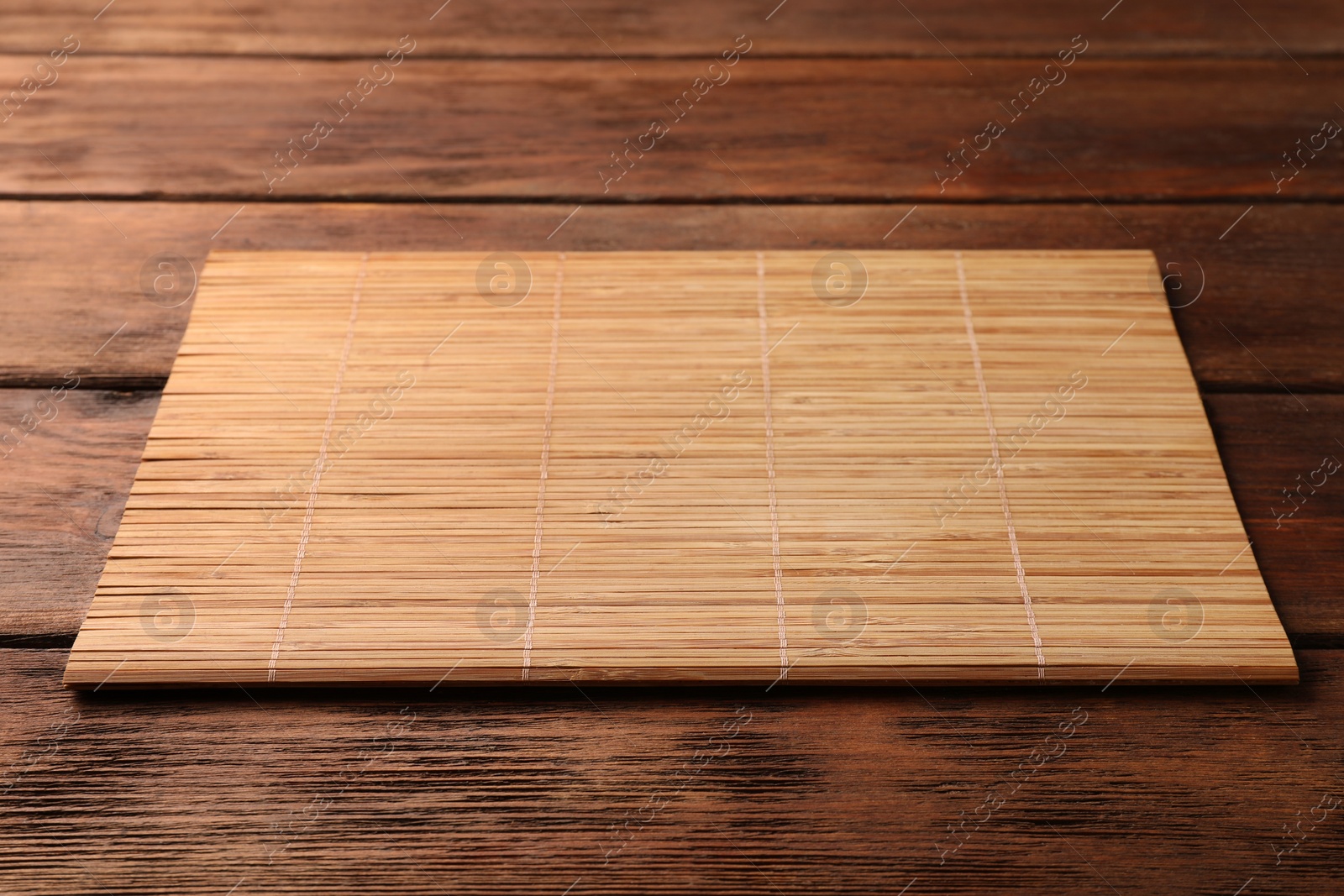 Photo of Bamboo mat on wooden table, space for text