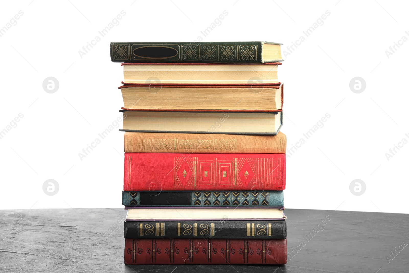 Photo of Stack of old vintage books on grey stone table against white background