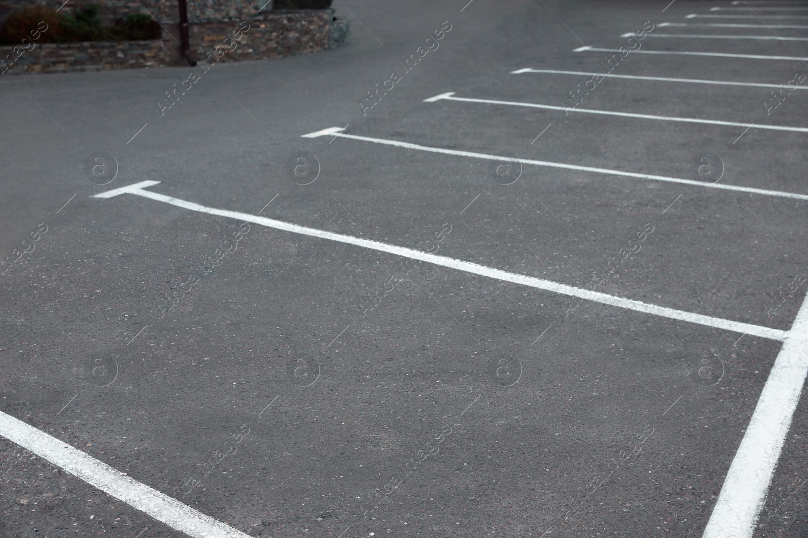 Photo of Car parking lots with white marking lines outdoors