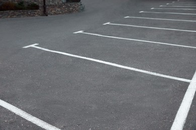 Photo of Car parking lots with white marking lines outdoors