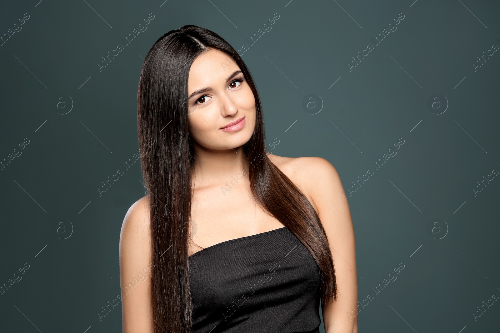 Photo of Portrait of beautiful model with gorgeous straight hair on color background