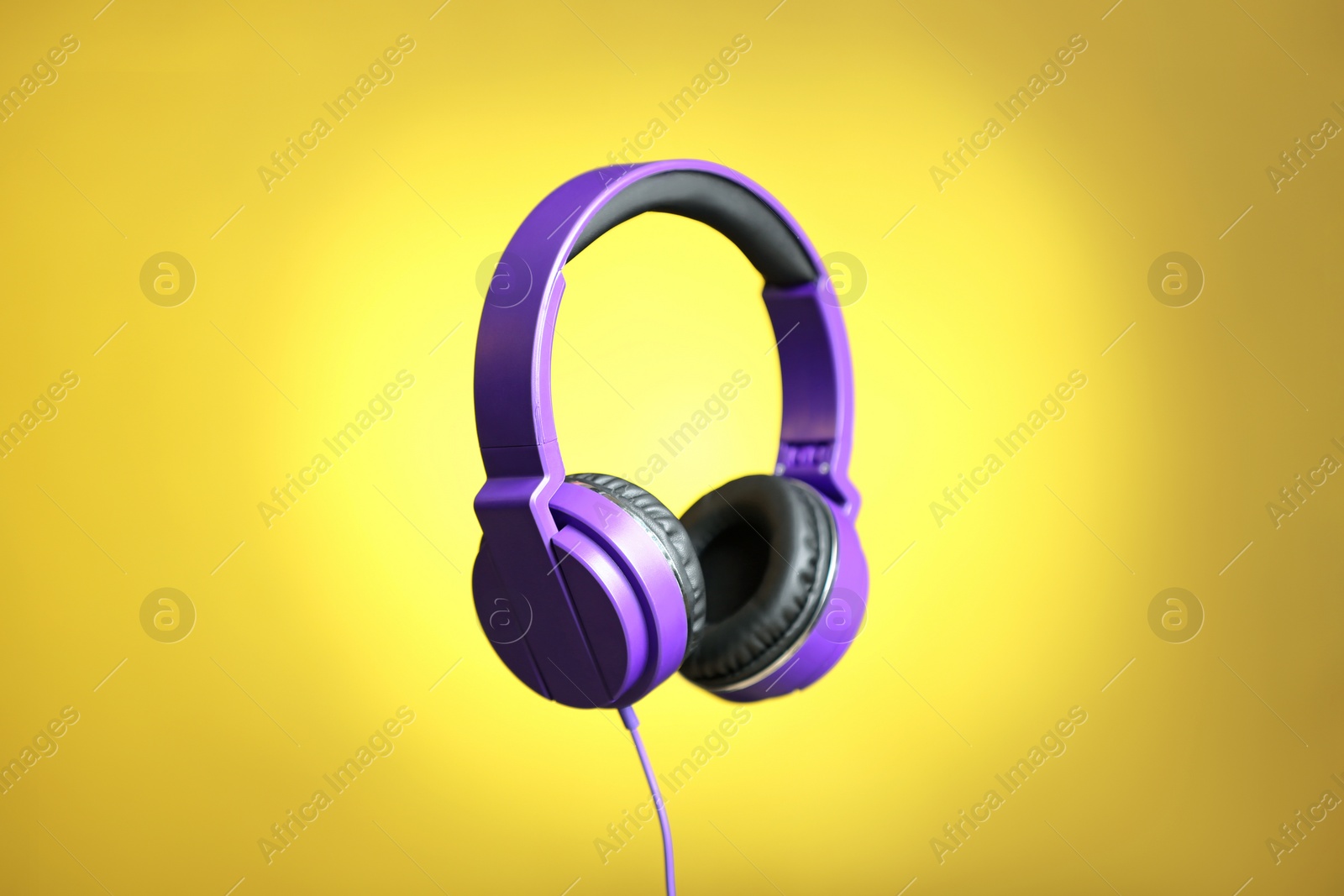 Photo of Stylish headphones with pads on color background