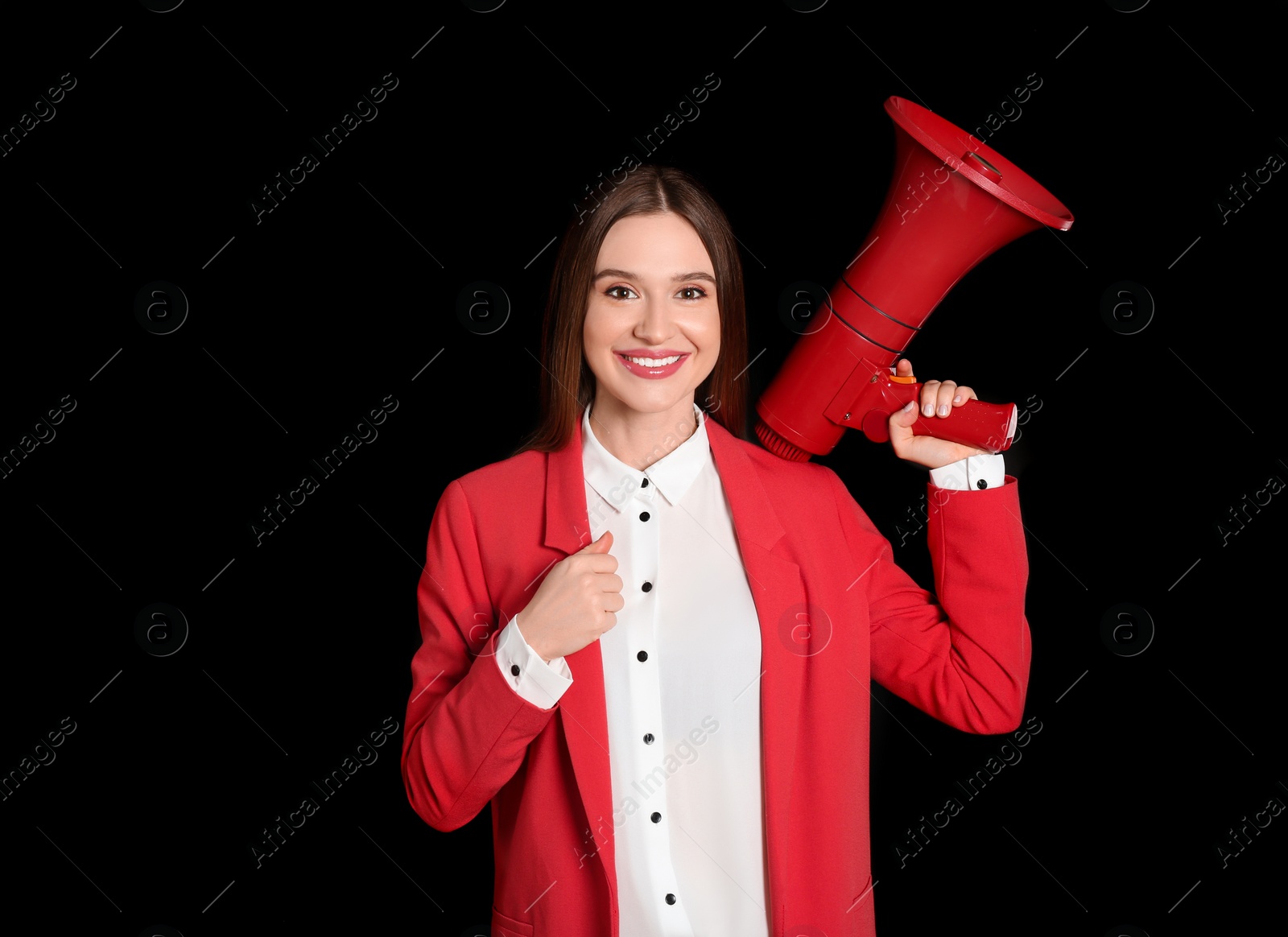 Photo of Young woman with megaphone on black background