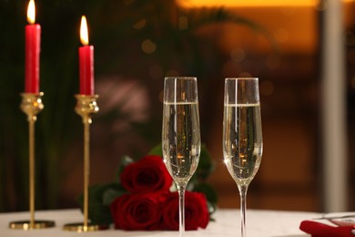 Photo of Glasses of champagne on table in restaurant. Romantic dinner