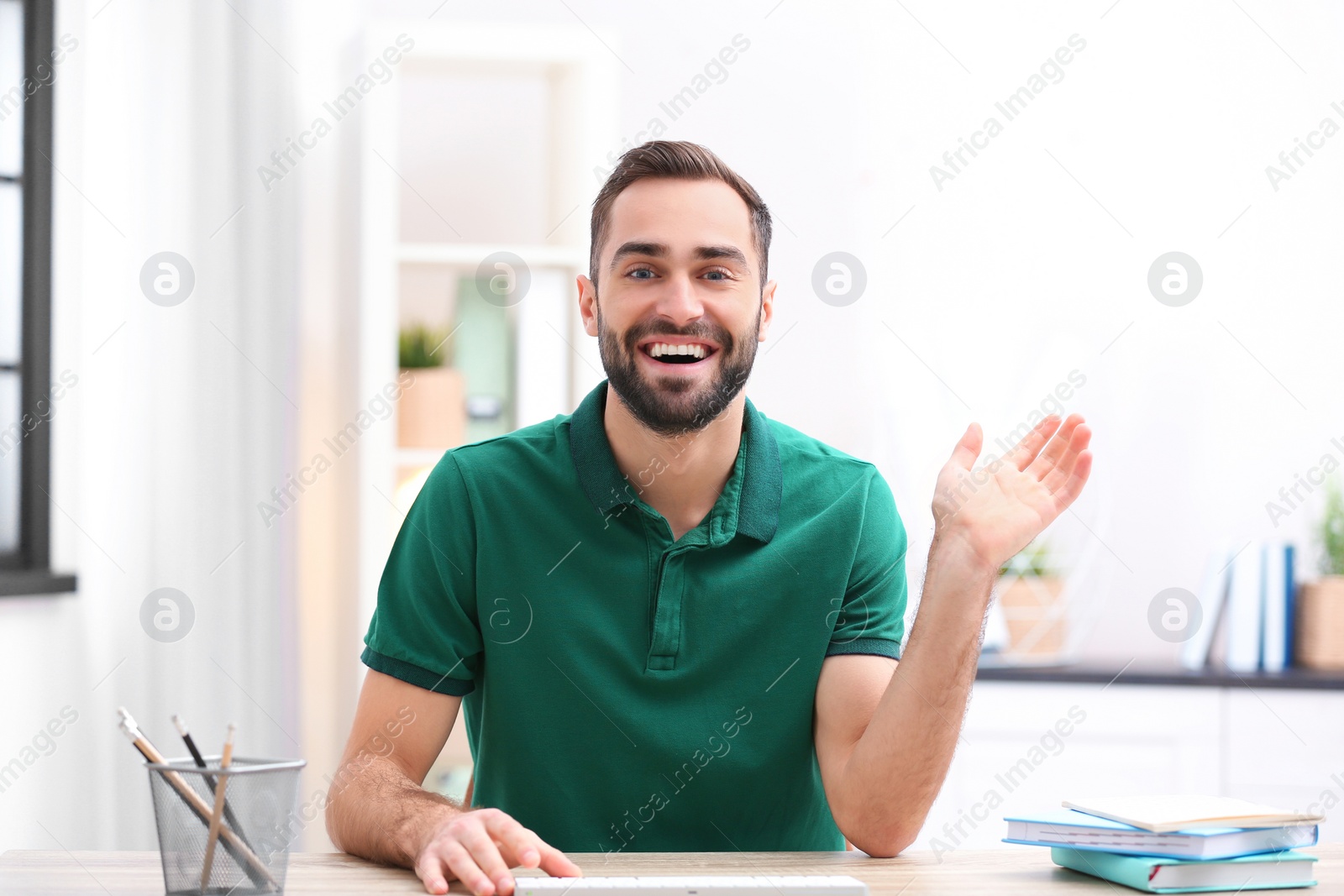 Photo of Handsome man using video chat for conversation indoors