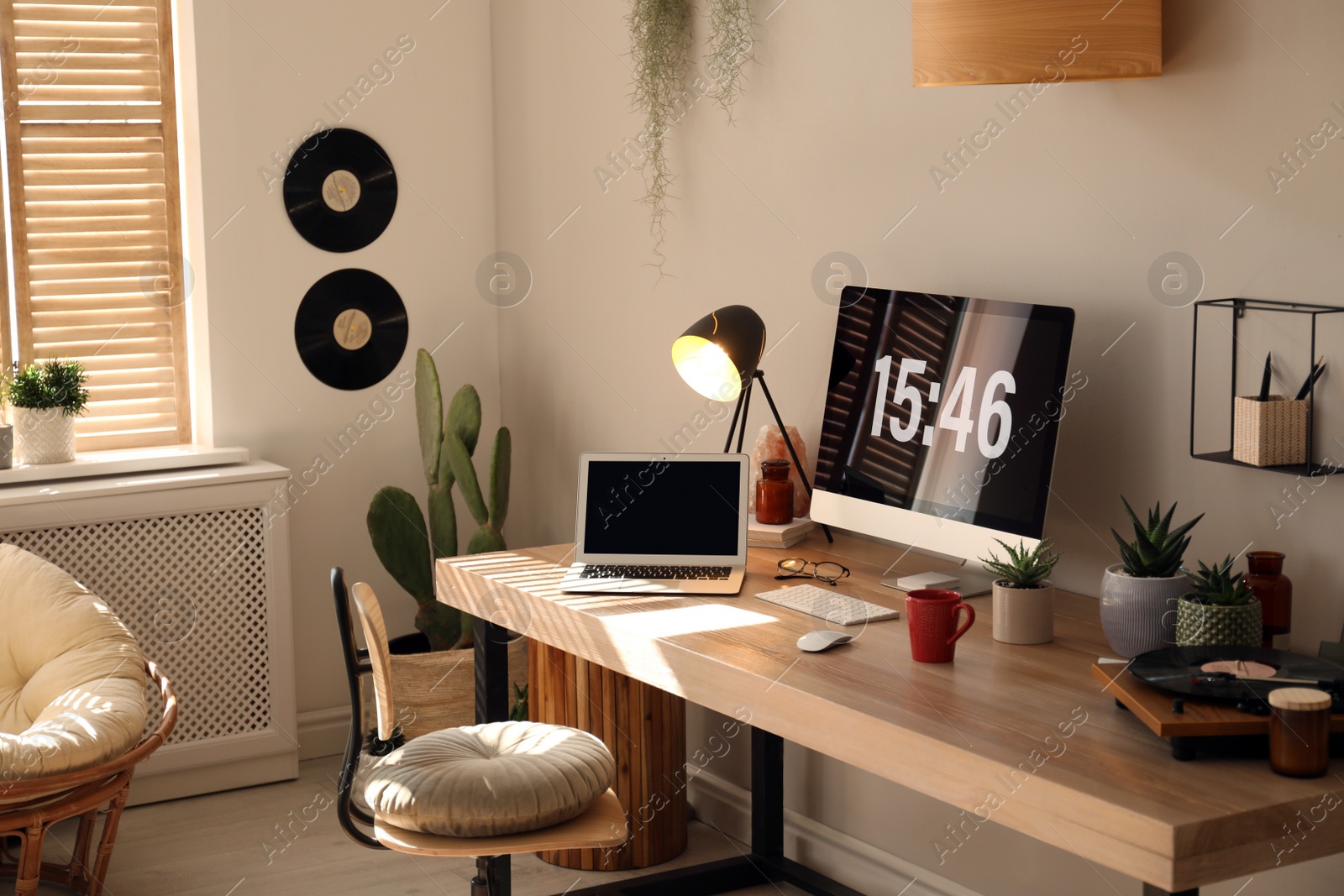 Photo of Room interior with comfortable workplace. Modern computer and laptop on wooden desk