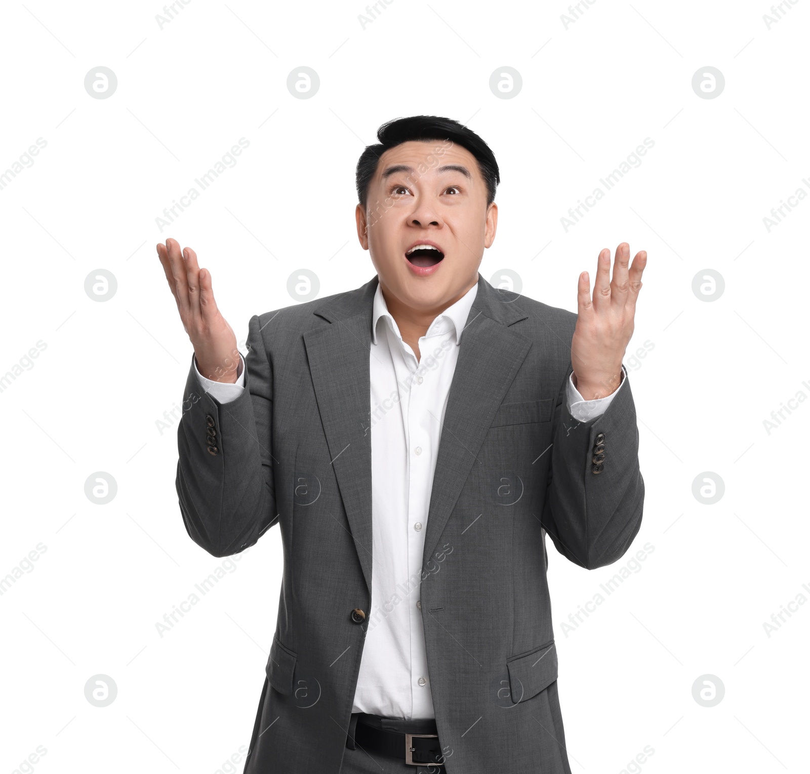 Photo of Shocked businessman in suit posing on white background