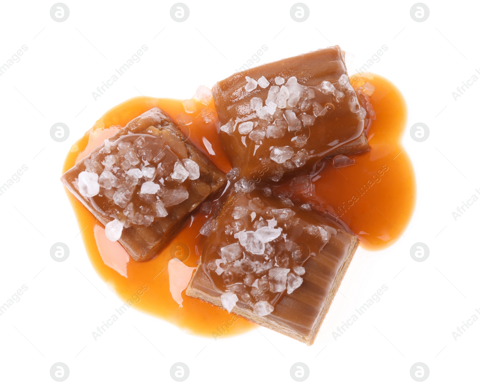 Photo of Delicious salted caramel with sauce on white background, top view