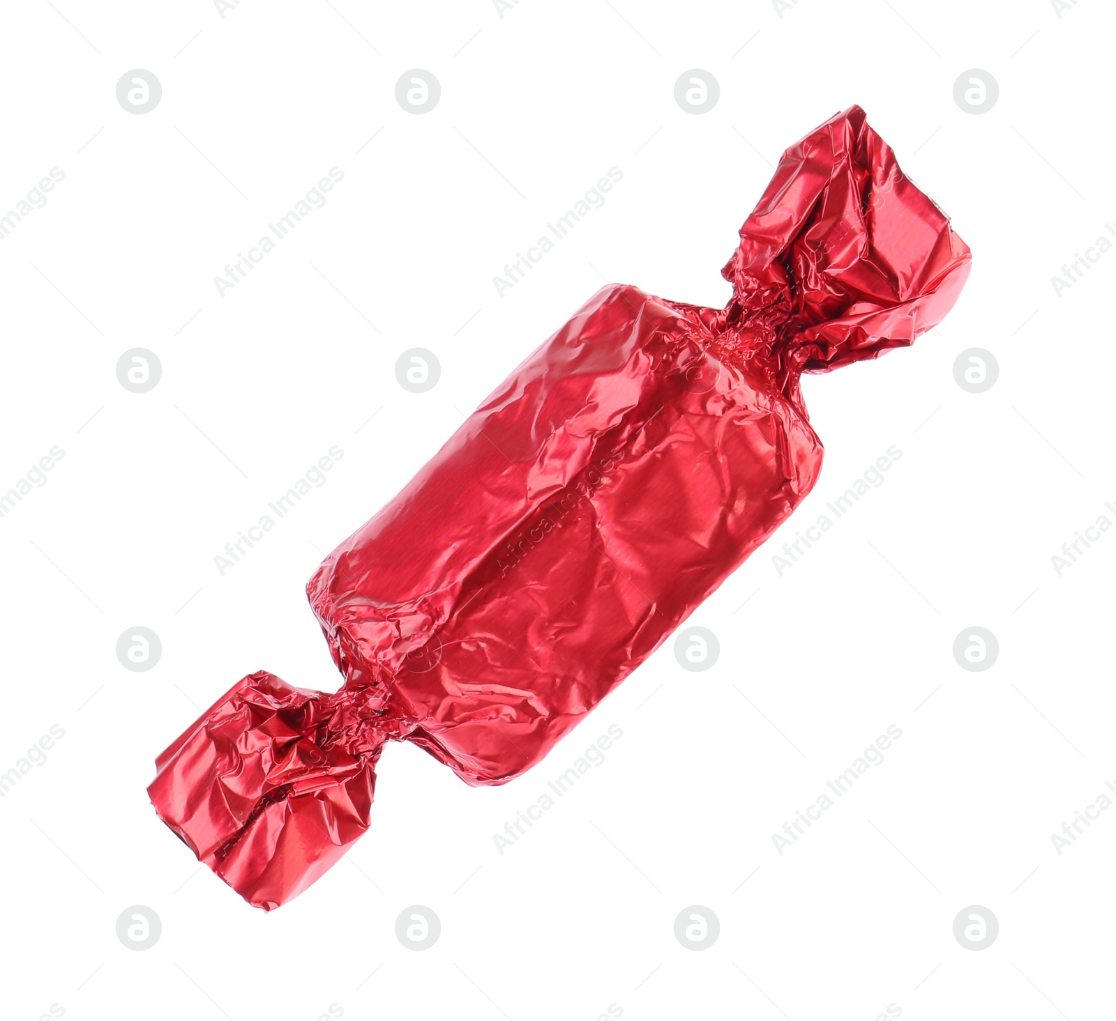 Photo of Tasty candy in red wrapper isolated on white