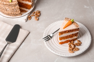 Photo of Sweet carrot cake with delicious cream on white marble table