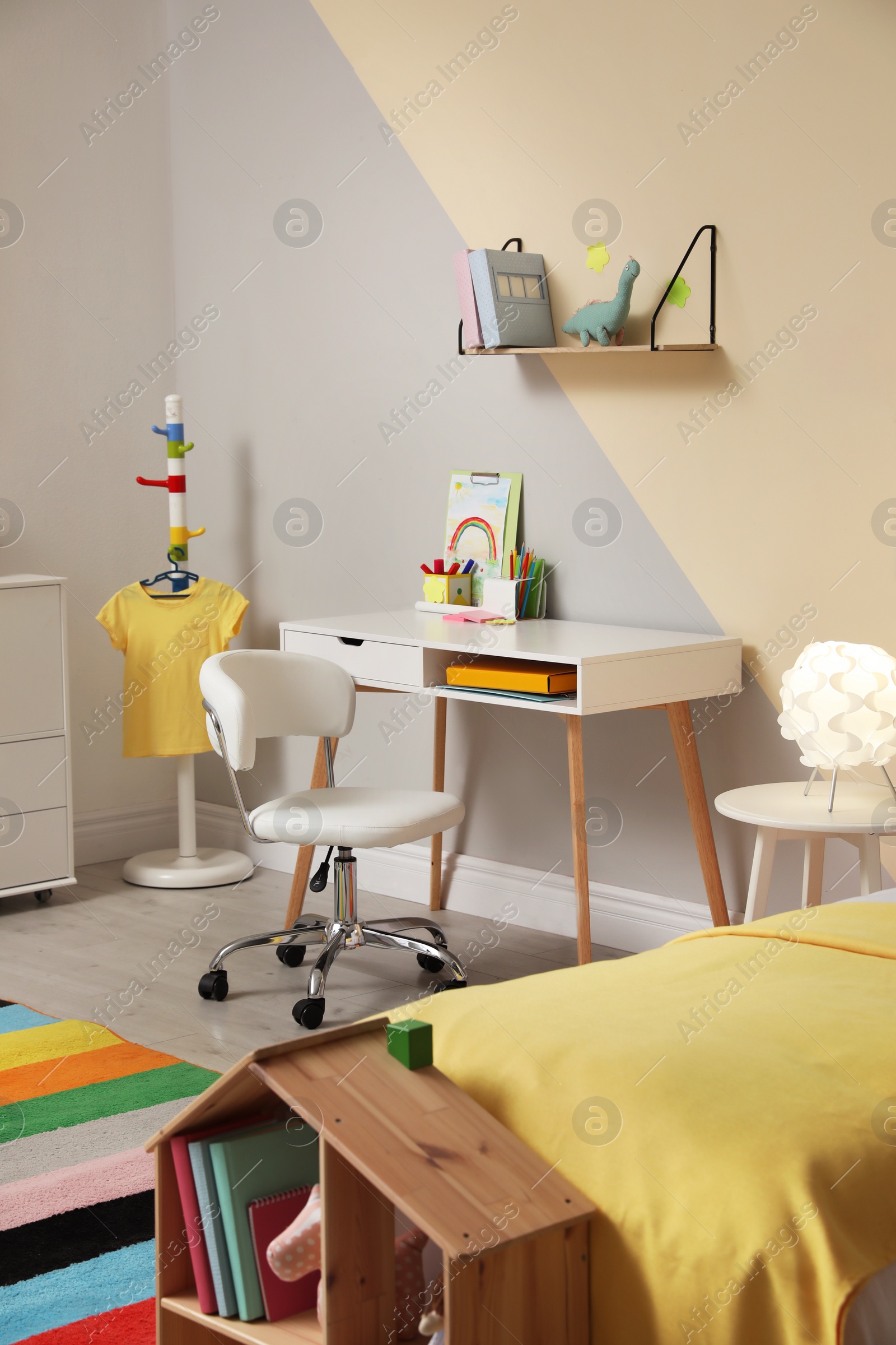 Photo of Stylish child room interior with comfortable bed and desk