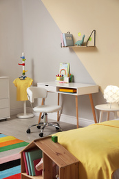 Photo of Stylish child room interior with comfortable bed and desk