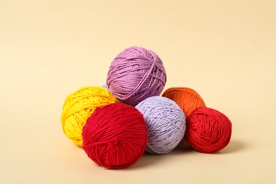 Photo of Soft colorful woolen yarns on beige background