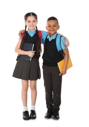 Photo of Full length portrait of cute children in school uniform with books on white background