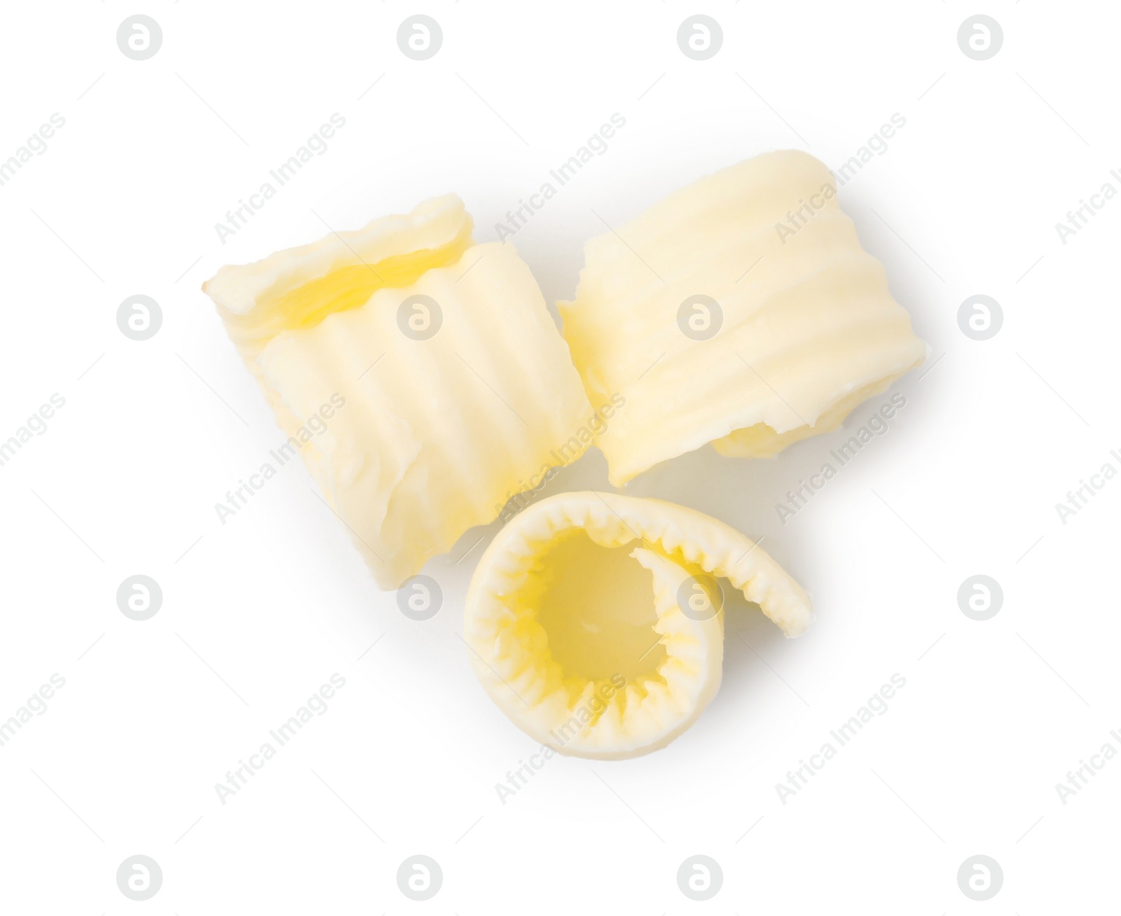 Photo of Fresh tasty butter curls isolated on white, top view