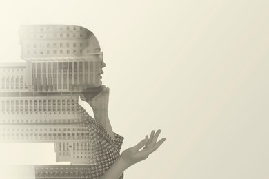 Image of Double exposure of businesswoman and cityscape with office buildings. Space for text