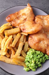 Photo of Tasty fish, chips and peas on grey table, top view