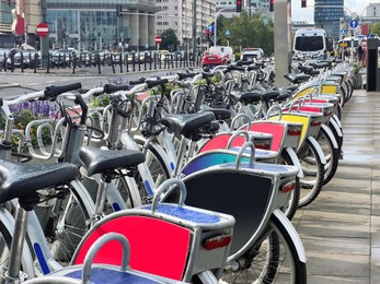 Photo of Many bicycles parked outdoors. Bike rental service