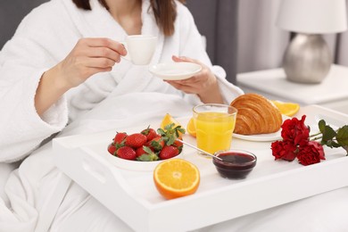 Photo of Woman having breakfast in bed at home, closeup