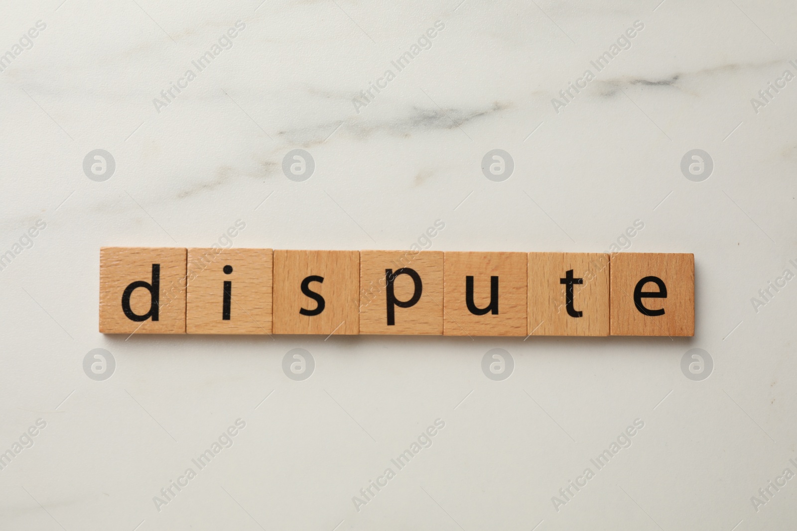 Photo of Squares with word Dispute on white marble table, top view