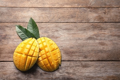 Photo of Flat lay composition with mango on wooden background. Space for text