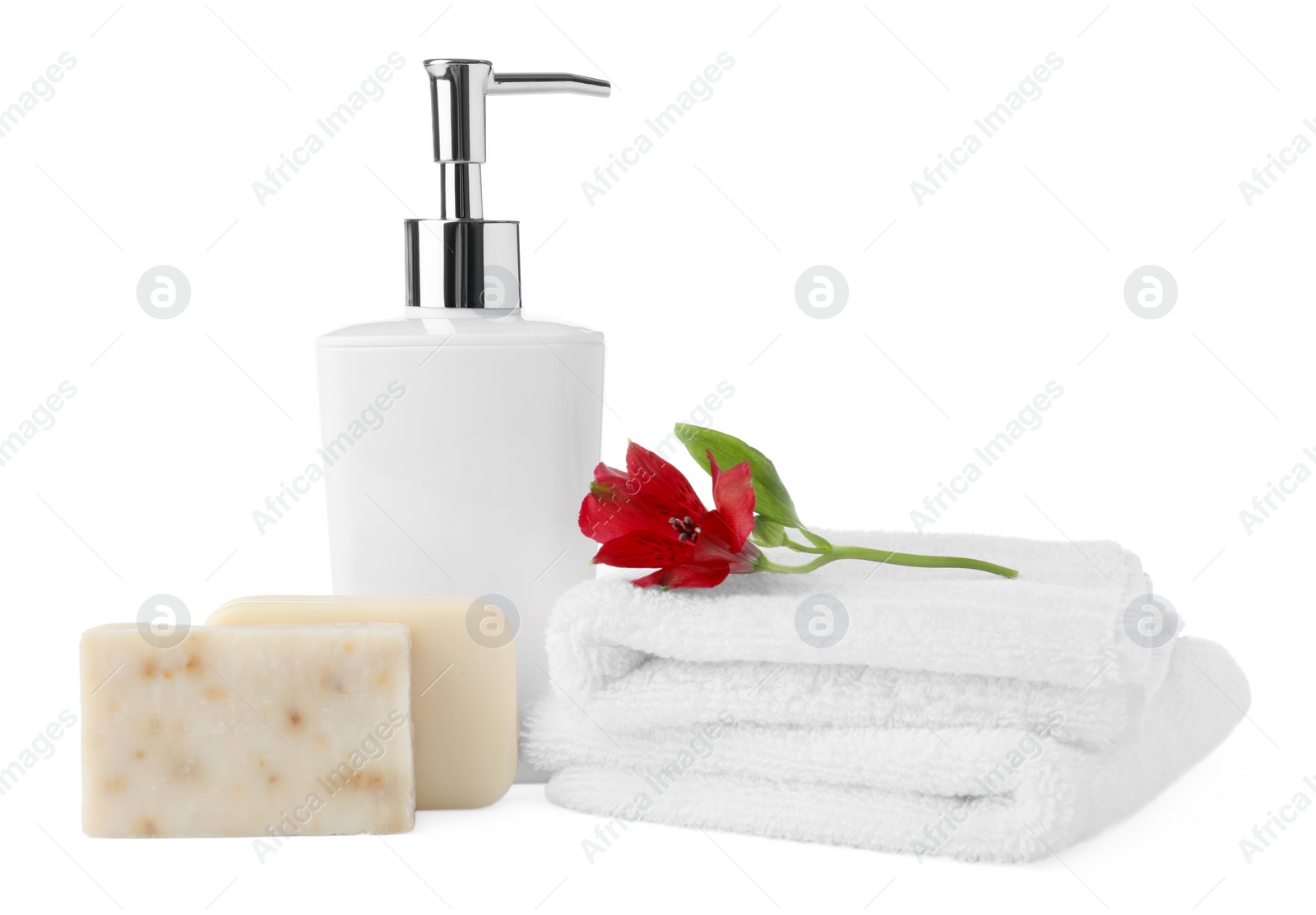 Photo of Soap bars, dispenser and terry towels on white background