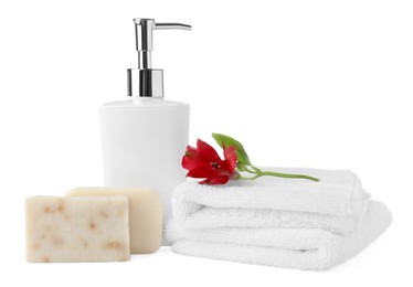 Photo of Soap bars, dispenser and terry towels on white background