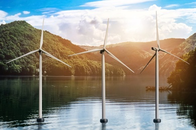 Floating wind turbines installed in water near mountains. Alternative energy source