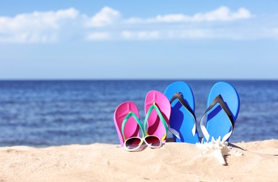 Composition with beach accessories on sand near sea in summer. Space for text