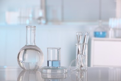 Laboratory analysis. Different glassware with liquid on white table indoors