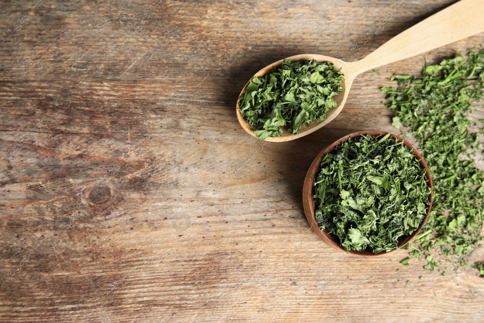 Photo of Flat lay composition with dried parsley on wooden table. Space for text