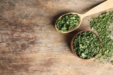 Photo of Flat lay composition with dried parsley on wooden table. Space for text
