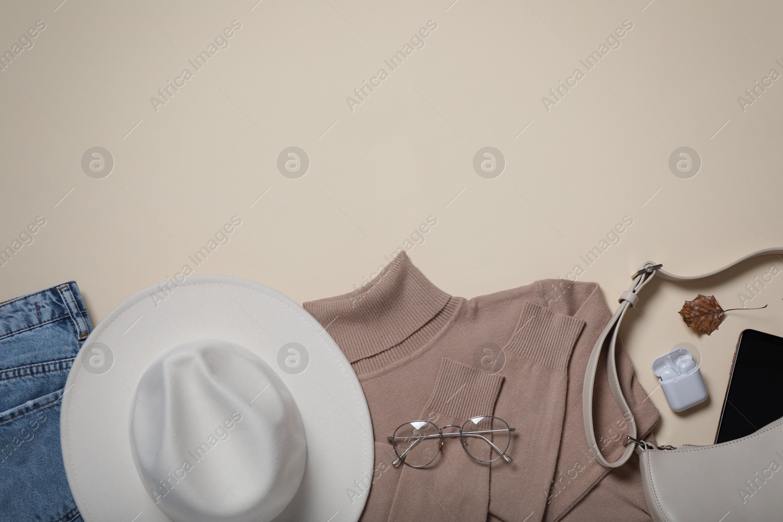 Photo of Flat lay composition with stylish hat and clothes on beige background, space for text
