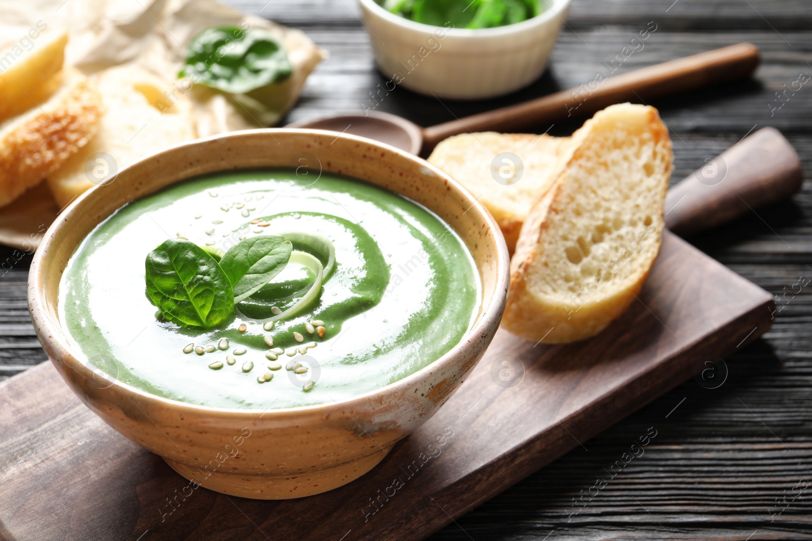 Photo of Fresh vegetable detox soup made of spinach served on table