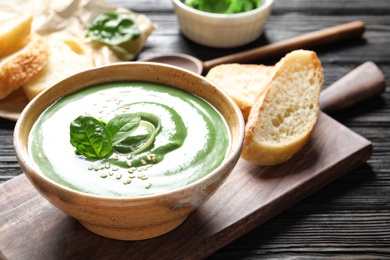 Photo of Fresh vegetable detox soup made of spinach served on table