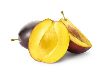 Photo of Whole and cut ripe plums on white background