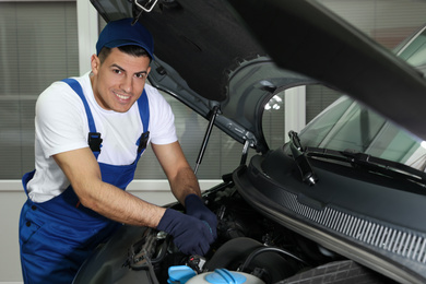 Photo of Mechanic fixing car at automobile repair shop