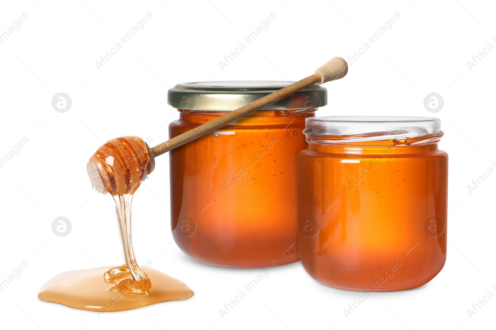 Image of Natural honey dripping from dipper and jars on white background