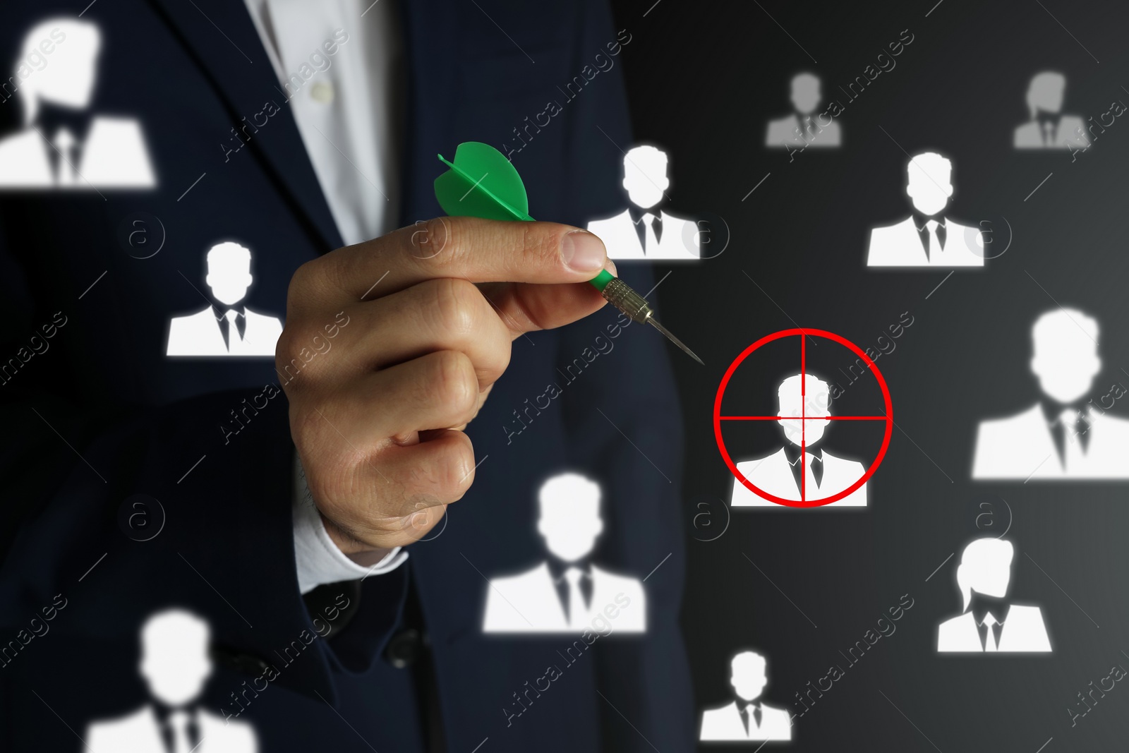 Image of Executive search (headhunting). Man aiming with dart to digital human icon on dark background, closeup
