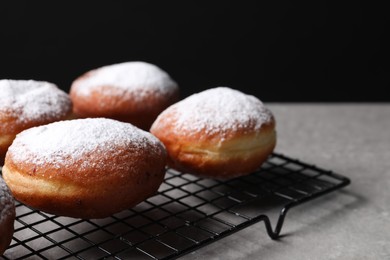 Delicious sweet buns on table against black background, closeup
