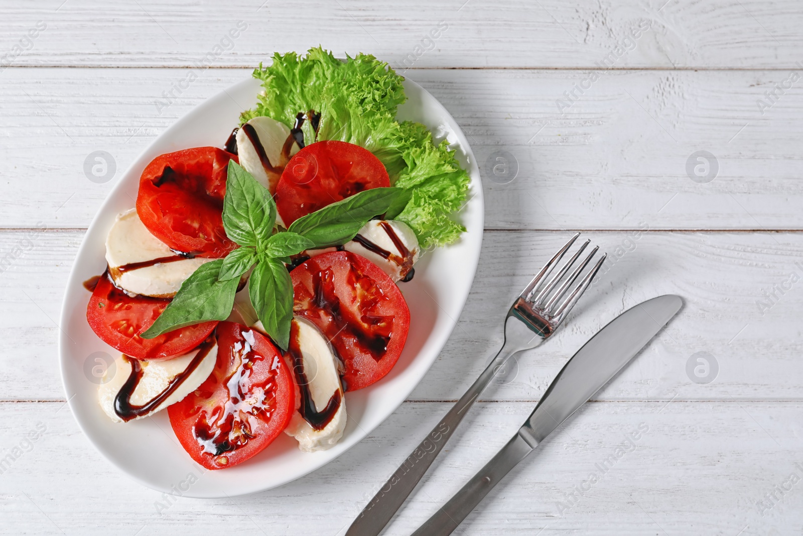 Photo of Plate with delicious fresh salad on table, top view