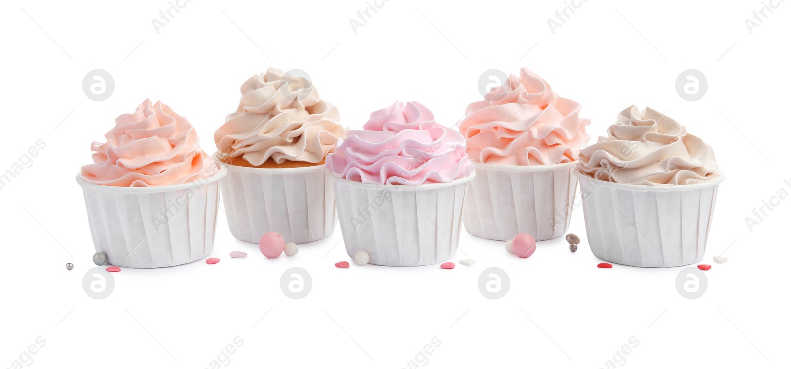 Photo of Tasty cupcakes with cream and sprinkles isolated on white