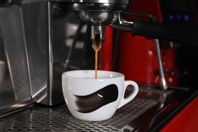 Photo of Making aromatic espresso using professional coffee machine in cafe