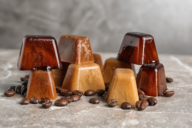 Ice cubes and coffee beans on grey table