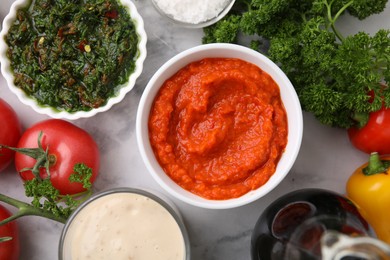 Photo of Different marinades and products on white marble table, flat lay