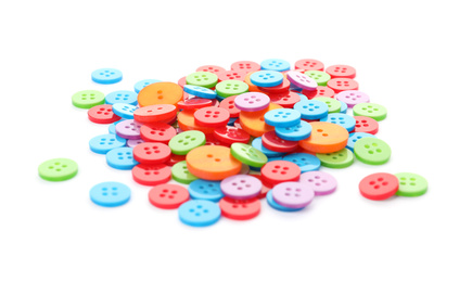 Photo of Many colorful plastic sewing buttons isolated on white