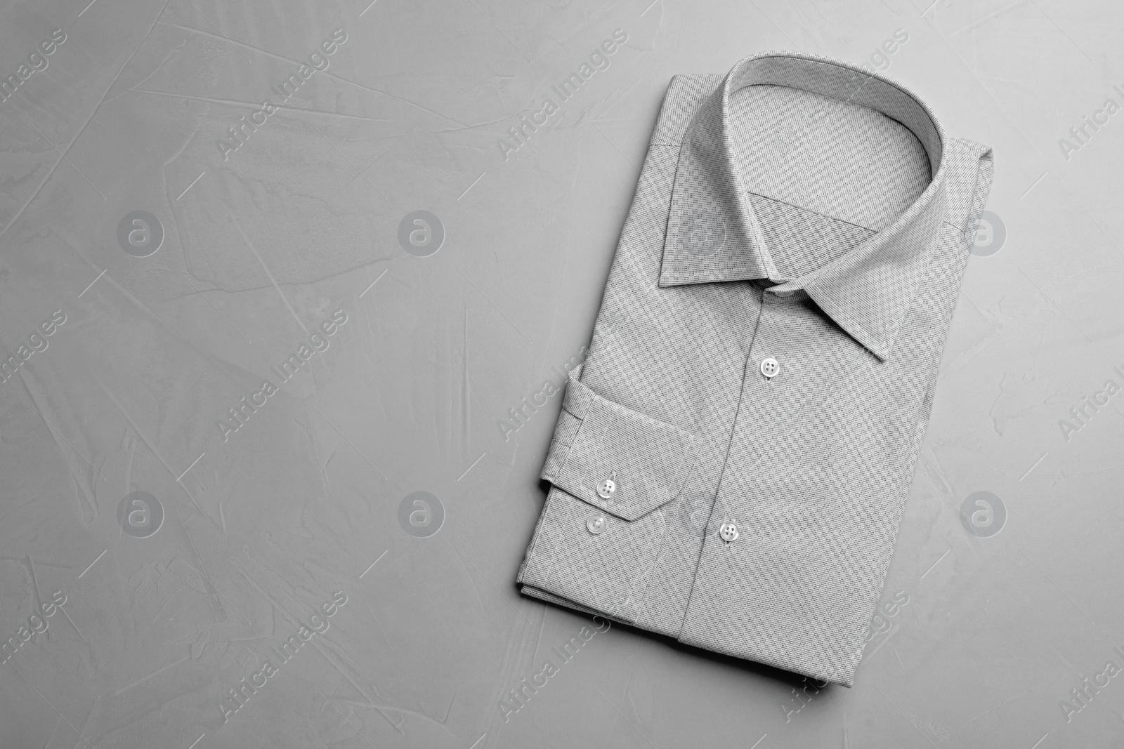 Photo of Male stylish grey shirt on light background, top view. Space for text