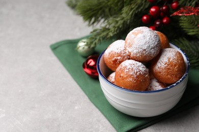 Delicious sweet buns in bowl and decor on gray table, space for text