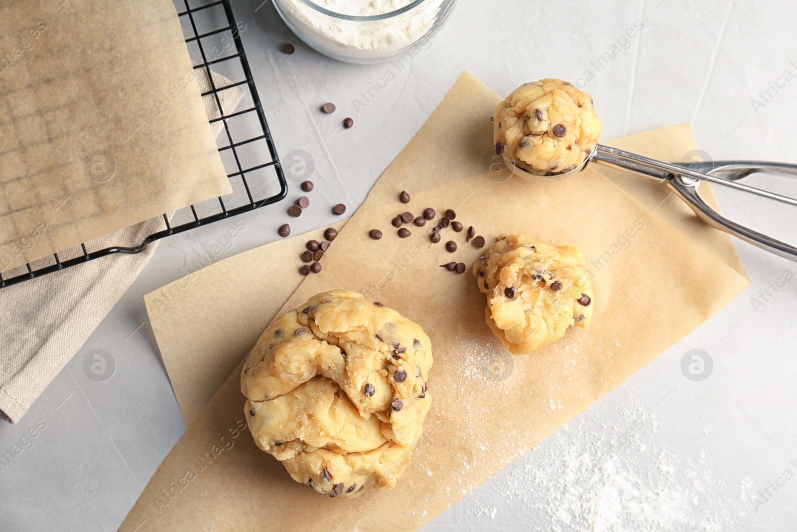 Photo of Raw cookie dough with chocolate chips on table, top view